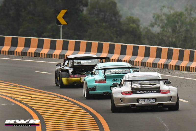 Three cars through mountain curve